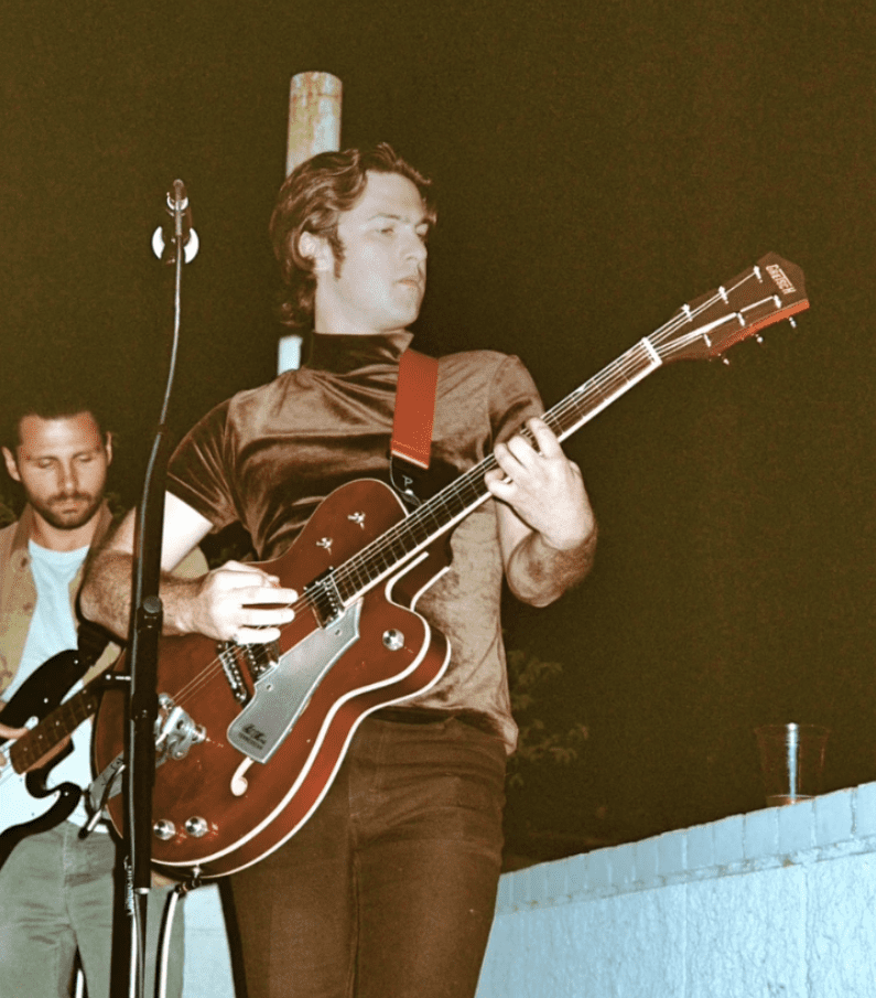 Phil Hollie playing a guitar